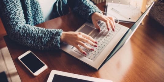 woman typing at table