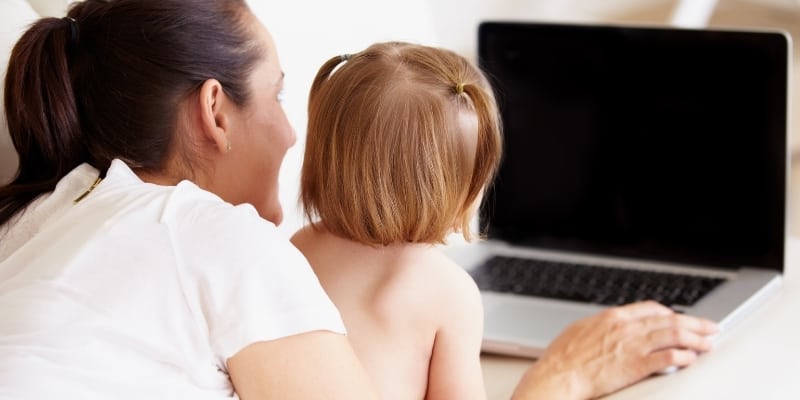 woman and child looking at laptop