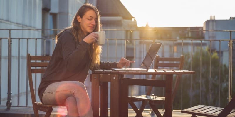 woman on balcony drinking