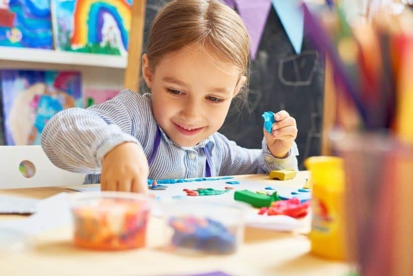 girl playing with craft gift