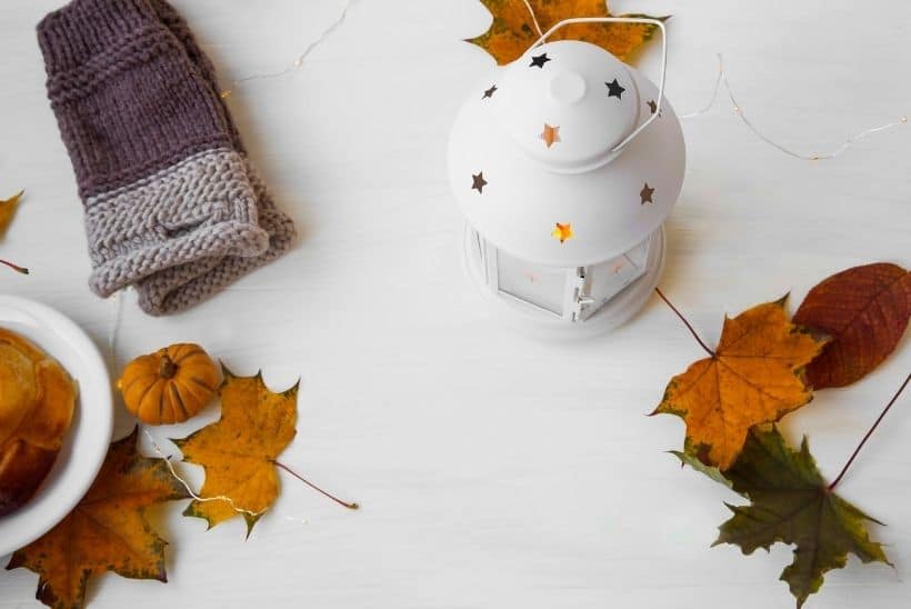 handwarmer and candles on white table