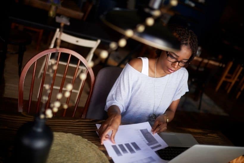 woman with stack of papers