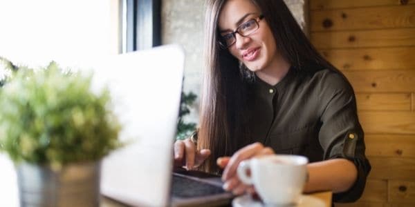 woman in glasses using laptop