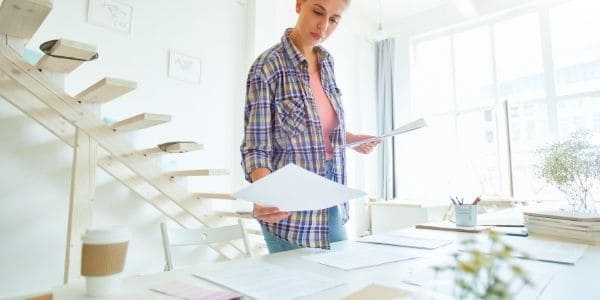 woman putting papers on table