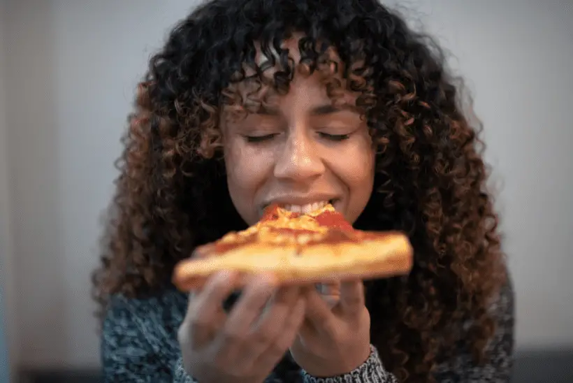 woman eating pizza