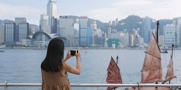 woman taking photos on harbor