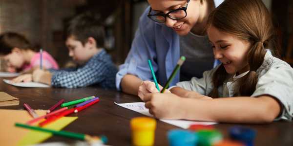 WOMAN WORKING AS ART INSTRUCTOR