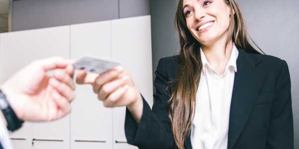 woman handing over business card