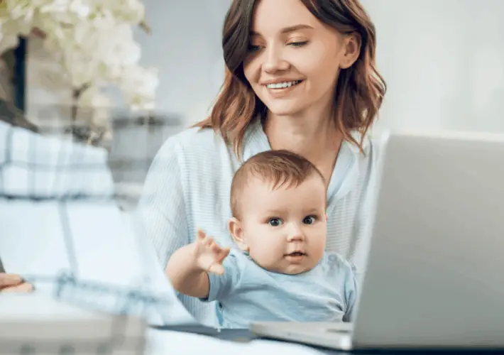 mom with baby doing chat job at home