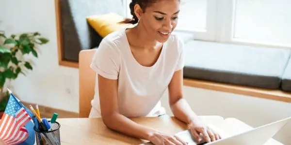 woman in white blouse using laptop