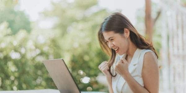woman at desk being excited