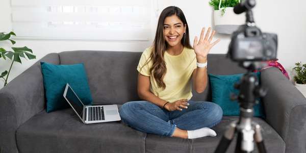 woman waves to camera