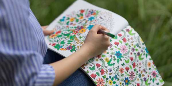 woman using a coloring book