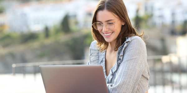 woman smiling using laptop