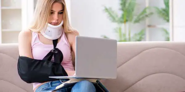injured woman using laptop